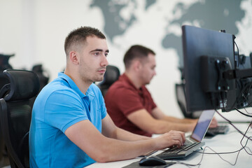 two male software developers working on computer