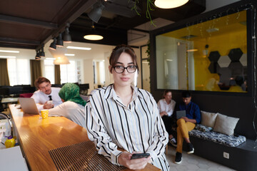 Wall Mural - portrait of businesswoman with glasses using mobile phone