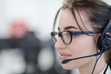 Wall Mural - Business woman with headsets at work