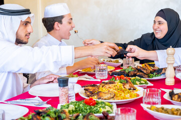 Wall Mural - Arabic muslim family eating together in a meeting for iftar in ramdan