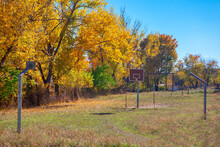 Autumn Scenery With Abandoned Basketball Court . Abandoned Sports Field In Rural Areas