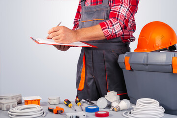 Wall Mural - Electrician draws up a work plan. Contract work.