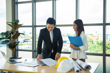 Young construction project engineer working with female secretary.