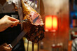 Barbecue leg of lamb on skewer - Churrasco Brazilian BBQ cooked on the rotisserie served by cutting meat directly off skewers table side, Dinner buffet seafood night.