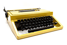 Vintage Mustard Yellow Typewriter On A White Background