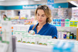 © Rido - Woman choosing product in pharmacy