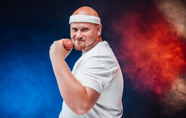 Paunchy man works out with a small dumbbell. He is wearing a white tracksuit and looks very pleased.