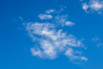 Clear blue sky with white clouds.