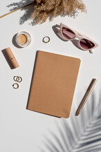Kraft Paper Cover Notebook Mockup. Feminine Stylish Desk. Beauty Accessories, Jewelry And Palm Leaf Shadow. Top View Vertical Mockup