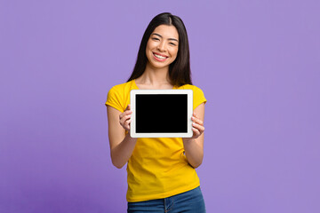 Check This Website. Smiling Korean Girl Demonstrating Digital Tablet With Black Screen