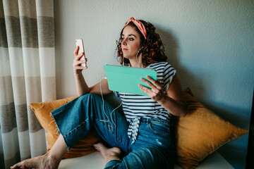 .Smiling young woman making a video call from home with her family. Moment of social distancing caused by covid19. Stay Home.