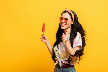 happy stylish summer brunette girl with ice cream on yellow background