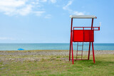 Fototapeta Miasta - Red lifeguard rescue tower on the Anaklia beach