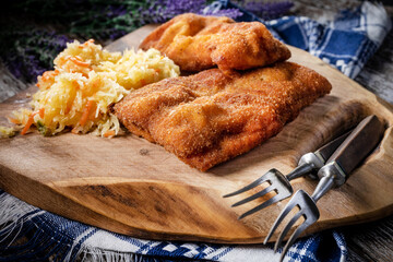 Two fried cod fillet pieces.