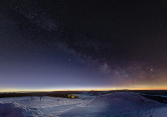 Canvas Print - Aerial shot of winter landscape under starry sky