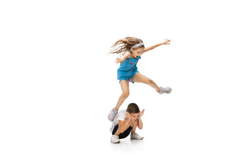 Wall Mural - Happy kids, little and emotional caucasian boy and girl jumping and running isolated on white background. Look happy, cheerful, sincere. Copyspace for ad. Childhood, education, happiness concept.