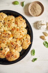 Sticker - Freshly-made delicious cheese bubble pizza bread with ingredients and cheese on a white table