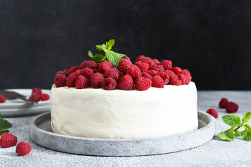 Wall Mural - Cake with cream cheese and raspberries and mint on the kitchen table. Birthday cake.