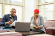 © Confidence - young african business man and woman going through some paperwork together
