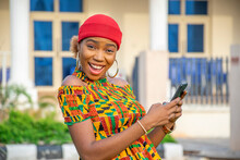 Excited Beautiful Young African Girl Holding Her Phone