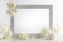 Still Life With White Flowers And Frame On Light Backdrop. Creative Concept For Celebration Of Mother Day, Birthday, Wedding Or Valentines Day