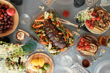 Wall Mural - High angle view of meat with vegetable and other delicious dishes on the table prepared for holiday dinner