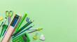 © Rawf8 - School supplies on green color background, top view, copy space