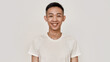© Svitlana - Smile. Portrait of young asian man with clean shaven face smiling at camera isolated over white background. Beauty, skincare, health concept