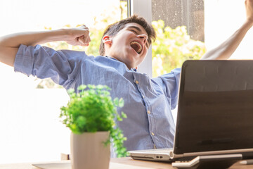 Poster - tired or lazy student at the desk with computer