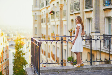 Sticker - Woman in white dress walking on famous Montmartre hill in Paris, France at early morning