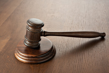 Judge (auction) gavel on an oak table