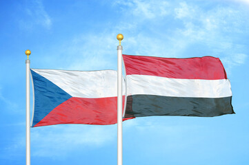 Czech and Yemen two flags on flagpoles and blue cloudy sky