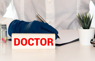 Doctor holding clipboard with word doctor on white background, closeup