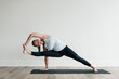 Young woman doing difficult yoga pose