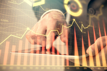 Multi exposure of man's hands holding and using a phone and financial chart drawing. Market analysis concept.