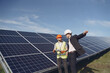 © prostooleh - Businessman and worker near solar energy batteries. Business client showing photovoltaic detail to foreman. Two men making deal.