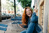 Fototapeta  - Vivacious young woman enjoying a good laugh