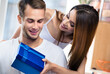 © vgstudio - Portrait image of happy excited smiling couple with gifts boxes, at home. Shopping, sales, holidays love, relationship concept - young man and woman posing together, indoos.