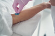 Experienced cosmetician setting intravenous catheter for a female