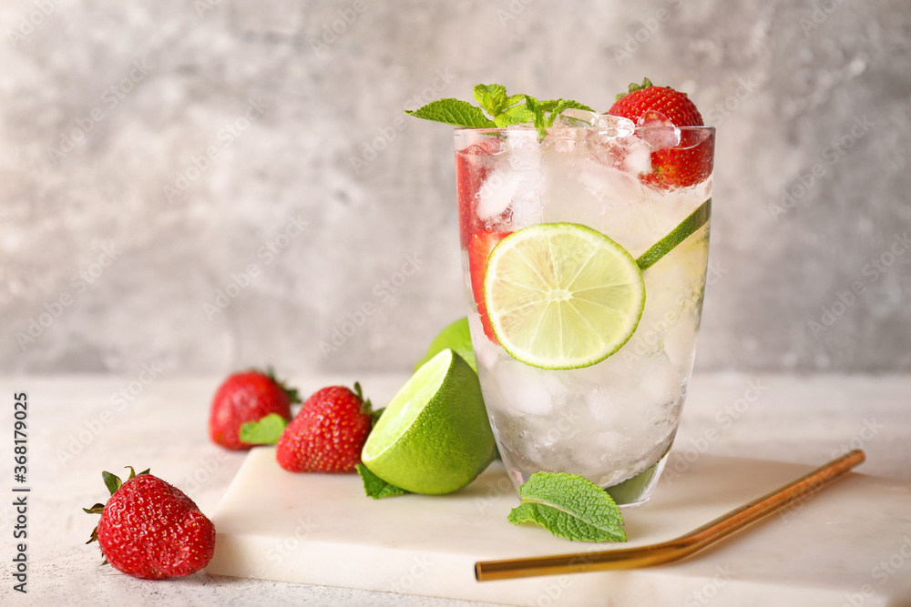 Glass of fresh strawberry lemonade on table