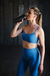 © Kostiantyn - beautiful woman going to drink some water from plastic bottle after workout