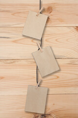 Wall Mural - clothespin hanging with blank paper on wooden background
