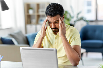 Canvas Print - technology, remote job and business concept - disappointed indian man with laptop computer working at home office