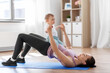 © Syda Productions - family, sport and motherhood concept - mother with little baby exercising at home