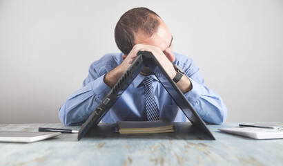 Wall Mural - Caucasian stressed businessman sitting in office.