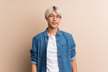 Young asian man over isolated background with glasses