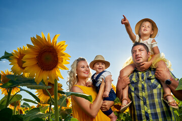 Young family in a sunflower field