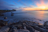 Fototapeta Zachód słońca - beautiful sunrise on the rocky beach