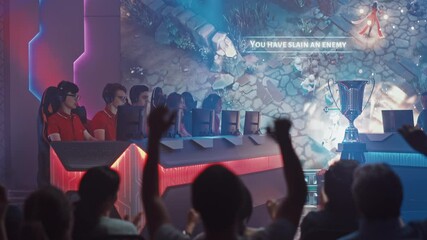 Wall Mural - Two Esport Teams of Pro Gamers Play in RPG Strategy Video Game on a Championship Arena, Happy Red Team Wins Round and Celebrates with High-Fives.Big Screen Showing Mock-up Gameplay. Cyber Games Event