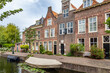 Cityscape Leiden street view with typical Dutch gable houses and canal in the old city centrer of Leiden in the Netherlands